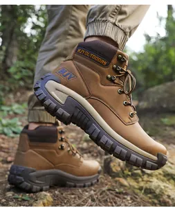 Close-up of brown outdoor tactical boot showing the non-slip thick rubber sole on terrain
