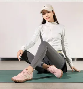 Close-up of pink minimalist barefoot sneakers with textured non-slip rubber soles