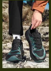 Close-up of breathable mesh material and chunky non-slip sole on black-green sneakers