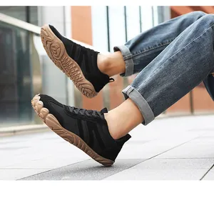 Close-up of flexible black mesh outdoor sneakers with non-slip brown rubber gum soles