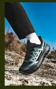 Detail of breathable hiking shoe with thick anti-slip sole on rocky outdoor terrain