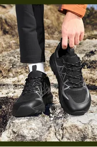 Detail of breathable mesh upper and textured rubber sole on black outdoor running shoes