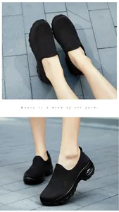 Detail view of black breathable knit sneakers with thick air cushion sole for women