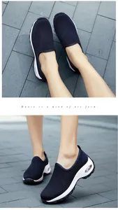 Detail view of breathable navy knit slip-on sneakers with thick air cushion soles