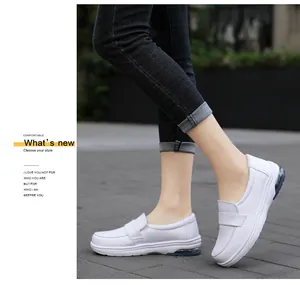 Detail shot of white slip-on shoes with visible blue air cushion for walking comfort