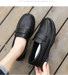 Close-up of black loafers featuring a thick air-cushion sole and smooth leather finish