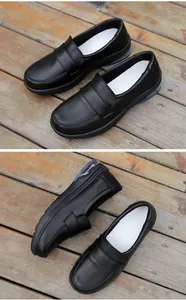 Detail view of black leather work shoes with visible blue air cushion for cushioning