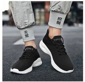 Macro shot of black knit sneaker with white wavy cushioning sole and SPORT print