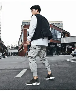 Tactical streetwear outfit featuring a grey cargo pant and olive green woven sneakers