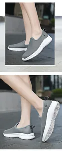 Detail of grey mesh running shoes showing breathable fabric and non-slip white soles