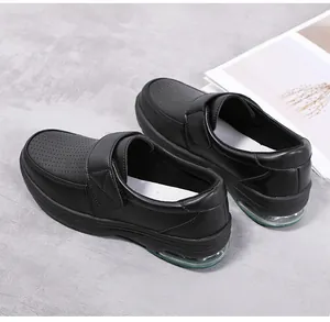 Detail view of black nursing shoes with breathable perforations and air cushion sole