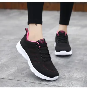 Dettaglio sneaker nera in mesh traspirante con accenti rosa e suola spessa bianca
