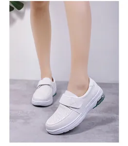 Detailed view of white velcro nursing shoes with breathable perforation and air cushion