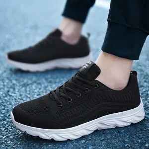 Detail of breathable knitted mesh and cushioned white sole on black men running shoes