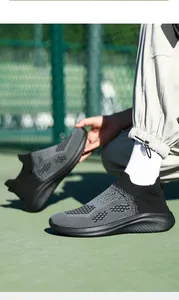 Detail view of breathable flying-knit casual sneakers for men in a gray and black sports style