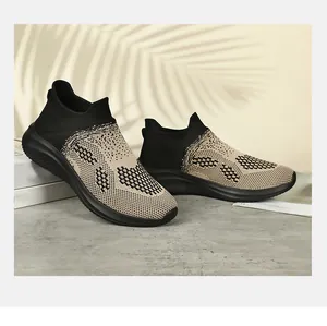 Detail of breathable knit upper and non-slip rubber sole on black-yellow running shoes