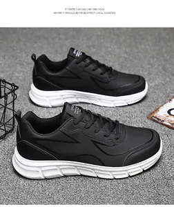 Detail of black waterproof casual sneakers for men on a grey textured carpet background