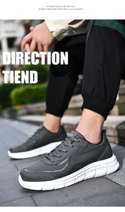 Close-up of low-top dark grey men's sneakers with white rubber sole on model