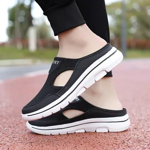 Detail view of black breathable mesh mule sneakers with thick white non-slip soles
