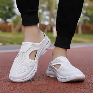 Close-up of white breathable mesh slip-on sports sandals with thick sole on running track
