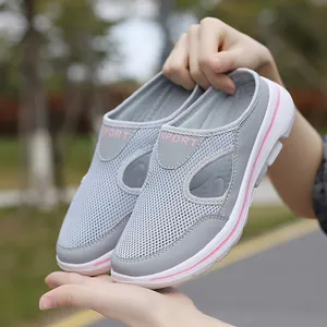 Detail of grey breathable mesh sport mules with thick white sole and pink SPORT text