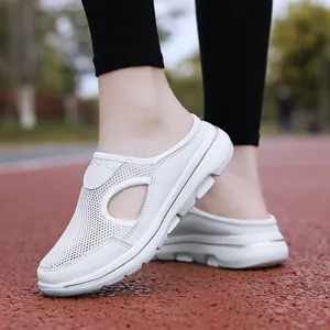 Detailed close-up of white mesh sports mule sneakers with hollow-out side design