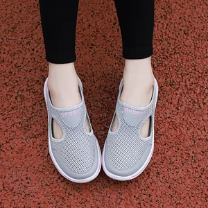 Close-up of breathable grey mesh slip-on sports sandals with pink accents and thick soles