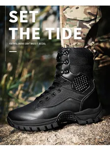 Detail of breathable black leather tactical boots with durable rubber soles on rocks