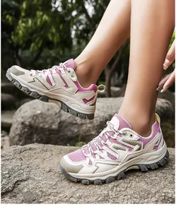 Outdoor shot of pink breathable mesh hiking shoes on rock with anti-slip rubber soles