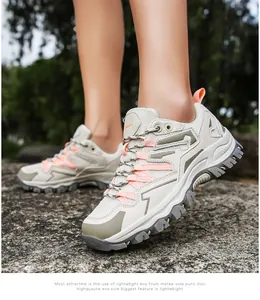Close-up of lightweight trekking shoes with mesh upper and EVA sole on rocky ground