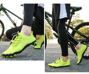Close-up of breathable mesh and quick-lace system on fluorescent green hiking water shoes