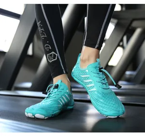 Detail of aqua water shoes with quick-lace system worn on a treadmill for gym workout