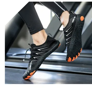 Action shot of barefoot running shoes on treadmill showing grip and orange rubber sole