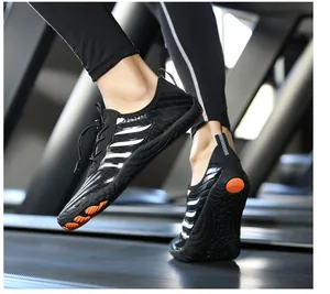 Close-up of non-slip outsole with orange grip pads on treadmill sport shoes