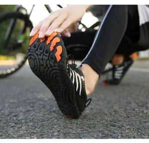 Close-up of durable rubber sole with orange anti-slip lugs on outdoor trekking shoes