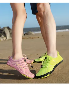 Outdoor beach scene with models wearing pink and neon green quick-dry water sports shoes