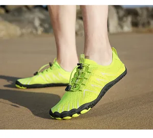 Detailed view of quick-dry water shoes with anti-slip rubber sole on a sandy beach