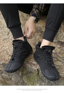 Close-up of black insulated hiking boots with warm faux fur lining and bungee lacing