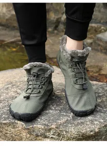 Detail of army green outdoor hiking boots with warm faux fur lining and bungee laces