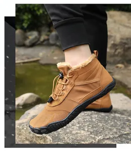 Close-up of brown hiking boots with plush fur lining and durable rubber toe cap