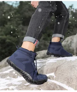 Waterproof winter hiking boots with fleece lining shown on snow-covered rocks