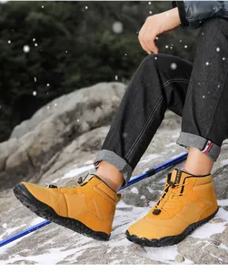 Detail of yellow waterproof outdoor snow boots with quick-lace system and anti-slip sole