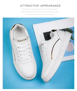 Detail view of white platform sneakers featuring golden side accents and lace-up design
