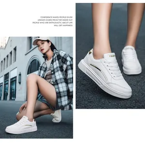 Detail of white women's sneakers featuring gold side stripes and platform non-slip soles