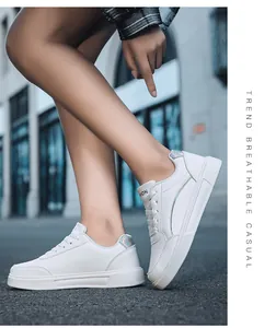 Detailed street view of platform white sneakers with silver accents and reflective heel