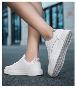 Close-up of white platform sneakers with silver holographic heel and non-slip wavy sole