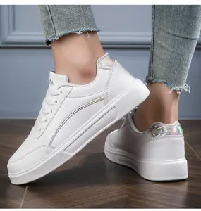 Detail view of white platform sneakers featuring iridescent holographic accents on the side