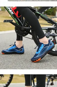 Detailed view of quick-dry water shoes with blue wave patterns and orange rubber soles