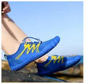 Close-up of blue quick-dry water shoes with non-slip rubber sole on seaside rocks
