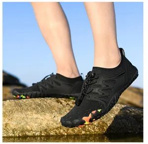 Outdoor water shoes with breathable black mesh and non-slip rubber sole on rocks